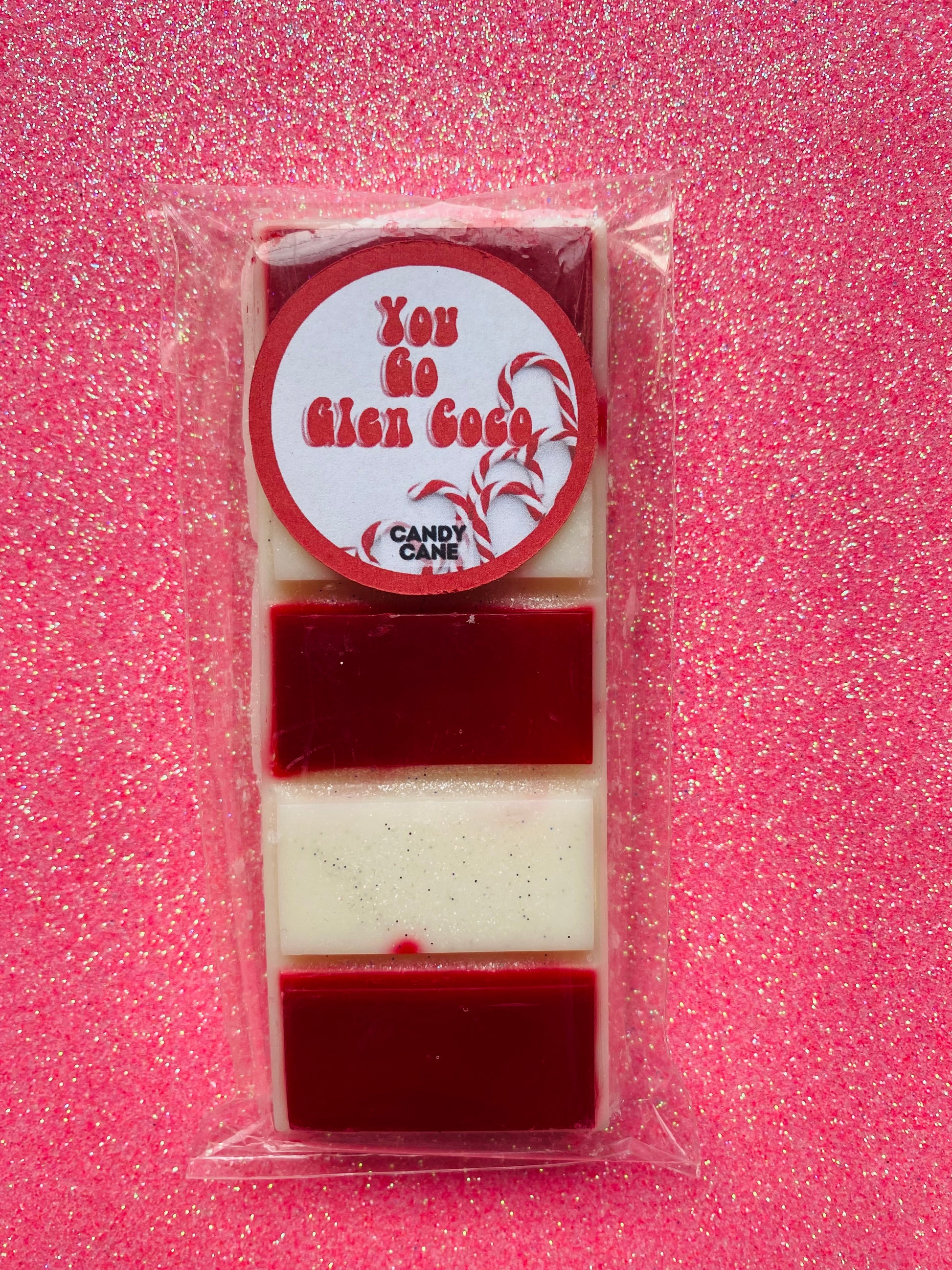 wax melts inspired by the Mean Girls movie, each with different colors and labels corresponding to different quotes from the film.