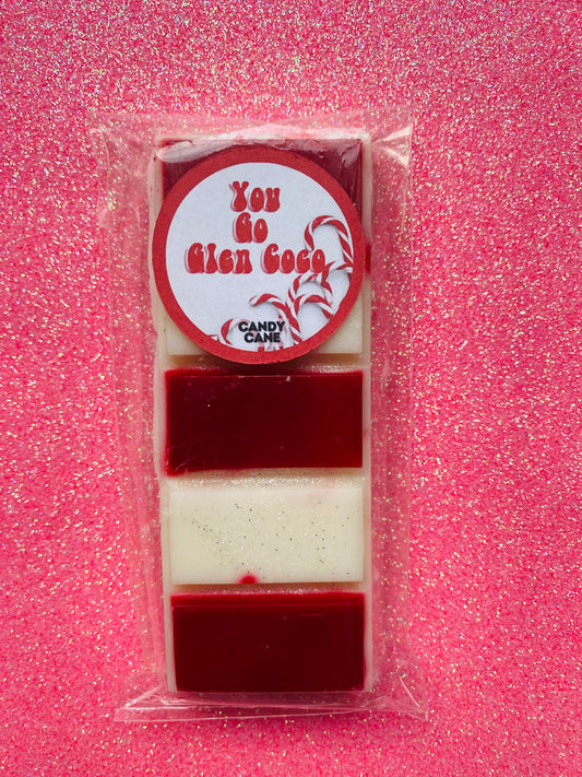 wax melts inspired by the Mean Girls movie, each with different colors and labels corresponding to different quotes from the film.