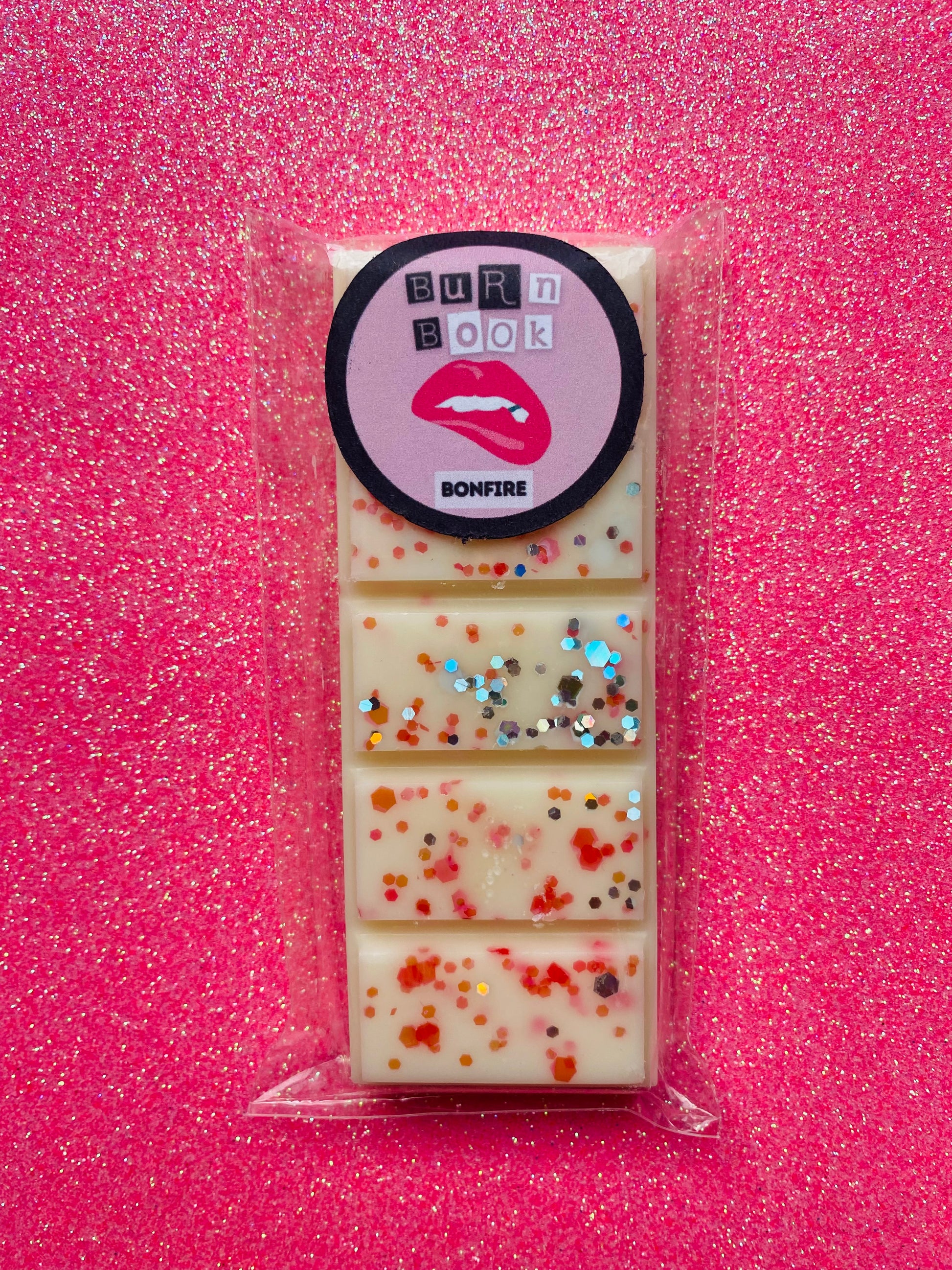 wax melts inspired by the Mean Girls movie, each with different colors and labels corresponding to different quotes from the film.